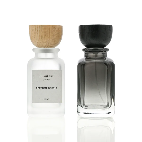 HUA0041 perfume bottle, frosted clear or smoky grey gradient cylindrical round glass bottle featuring an eye-catching inverted conical cup-shaped wood cap with prominent natural wood grain lines, elegant modern fragrance packaging design available in 30ml, 50ml, and 100ml