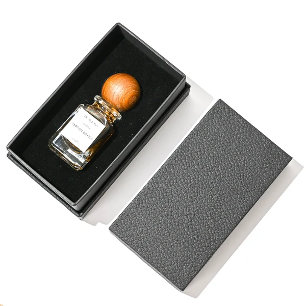 HUA0023 perfume bottle, heavy-base square cuboid glass bottle with clear finish and rounded edges, featuring a square paper label and an eye-catching inverted conical cup-shaped wood cap with prominent natural wood grain lines, elegant modern fragrance packaging design available in 30ml, 50ml, and 100ml