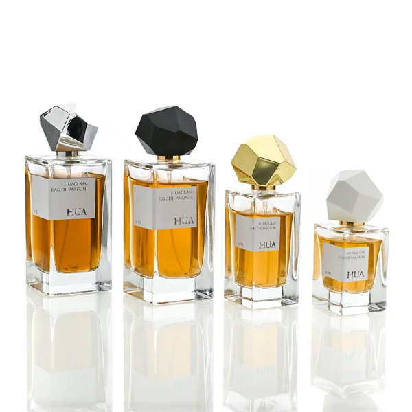 HUA0019 perfume bottle, heavy-base square cuboid glass bottle with clear finish, featuring a rectangular paper label and an eye-catching irregular multi-faceted rock-shaped plastic cap with a high-gloss white finish, elegant modern fragrance packaging design available in 30ml, 50ml, and 100ml
