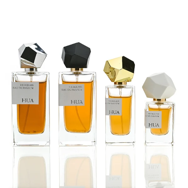 HUA0019 perfume bottle, heavy-base square cuboid glass bottle with clear finish, featuring a rectangular paper label and an eye-catching irregular multi-faceted rock-shaped plastic cap with a high-gloss white finish, elegant modern fragrance packaging design available in 30ml, 50ml, and 100ml