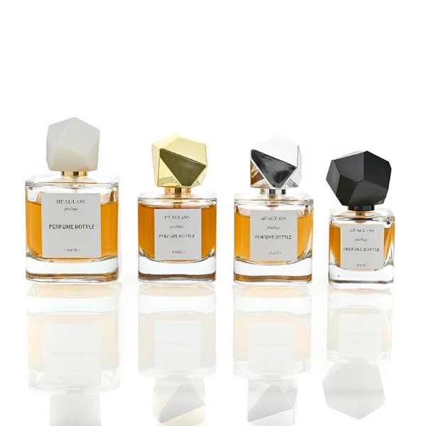 HUA0022 perfume bottle, heavy-base square cuboid glass bottle with clear finish, featuring a square paper label and an eye-catching irregular multi-faceted rock-shaped plastic cap with a high-gloss shiny finish and sharp geometric angles, elegant modern fragrance packaging design in 40ml