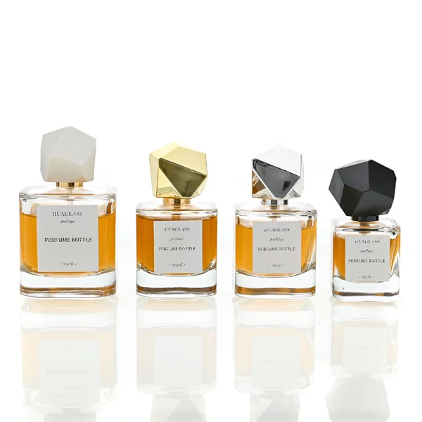 HUA0022 perfume bottle, heavy-base square cuboid glass bottle with clear finish, featuring a square paper label and an eye-catching irregular multi-faceted rock-shaped plastic cap with a high-gloss shiny finish and sharp geometric angles, elegant modern fragrance packaging design in 40ml