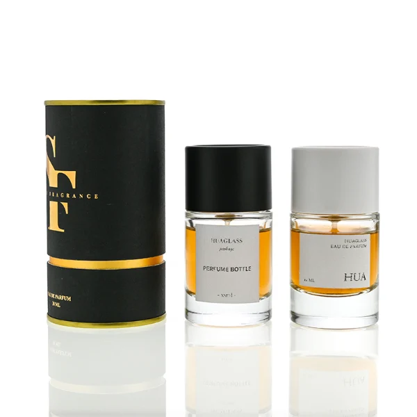 HUA0021 perfume bottle, heavy-base cylindrical round glass bottle with clear finish, featuring a square paper label, a matching neck, and a tall cylindrical plastic cap with a smooth high-gloss shiny finish, elegant modern fragrance packaging design available in 30ml, 50ml, and 100ml