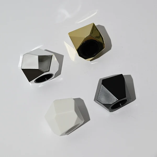 HUA0039 perfume bottle, heavy-base solid high-gloss opaque black cylindrical round glass bottle featuring a prominent asymmetrical multi-faceted polyhedral plastic cap with a smooth high-gloss shiny finish, modern dramatic fragrance packaging design available in 30ml, 50ml, and 100ml
