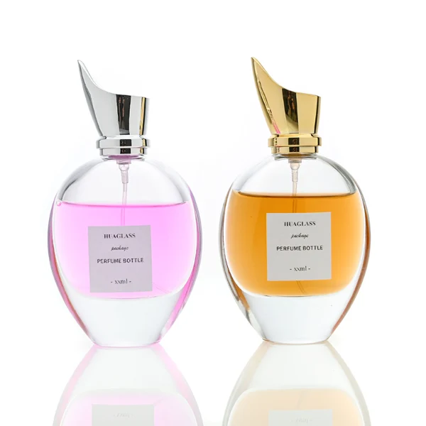 HUA0059 perfume bottle, heavy-base oval teardrop glass bottle with clear finish, featuring a square paper label, a matching neck, and a tall sculptural cylindrical plastic cap with a sharply angled sloping top in a smooth high-gloss shiny finish, elegant modern fragrance packaging design available in 30ml, 50ml, 75ml, and 100m