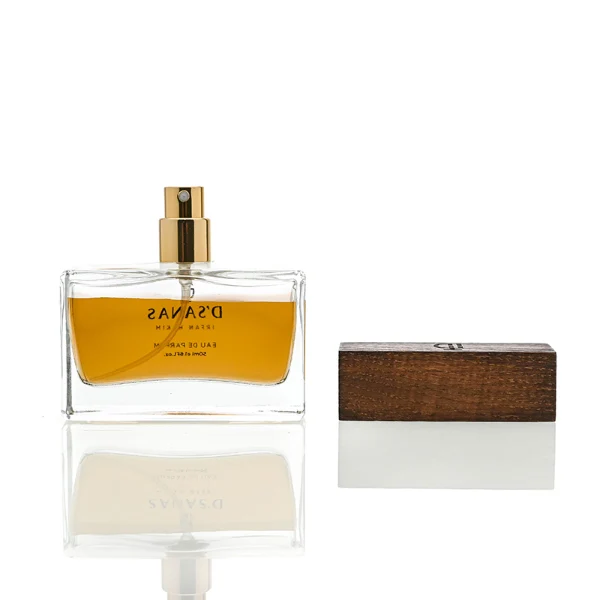HUA0036 perfume bottle, heavy-base wide rectangular cuboid glass bottle with clear finish, featuring a side-set paper label, a metallic gold collar neck accent, and a prominent wide rectangular block-shaped wood cap with prominent natural wood grain lines, elegant modern fragrance packaging design available in 30ml, 50ml, and 100ml