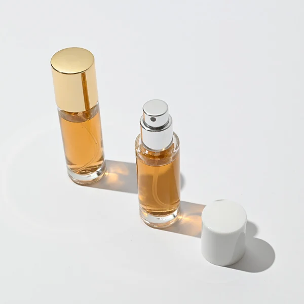 HUA0029 perfume bottle, slim cylindrical round clear glass purse-spray bottle featuring a tall cylindrical plastic cap with a smooth high-gloss shiny finish, elegant compact modern fragrance packaging design available in 10ml, 15ml, 20ml, and 30ml