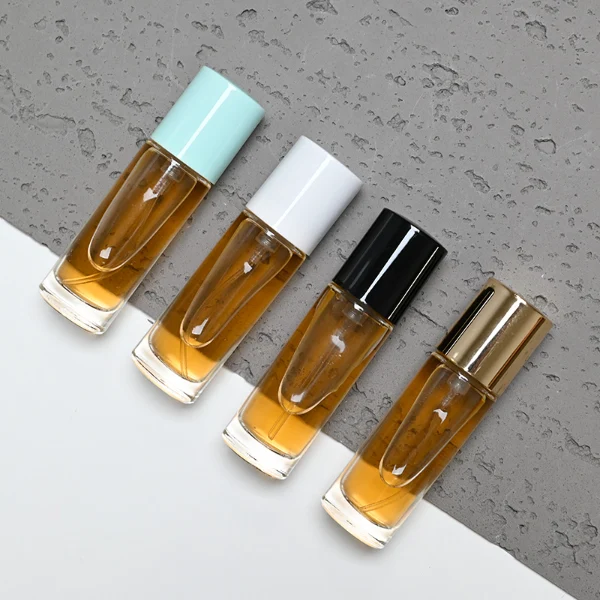 HUA0029 perfume bottle, slim cylindrical round clear glass purse-spray bottle featuring a tall cylindrical plastic cap with a smooth high-gloss shiny finish, elegant compact modern fragrance packaging design available in 10ml, 15ml, 20ml, and 30ml