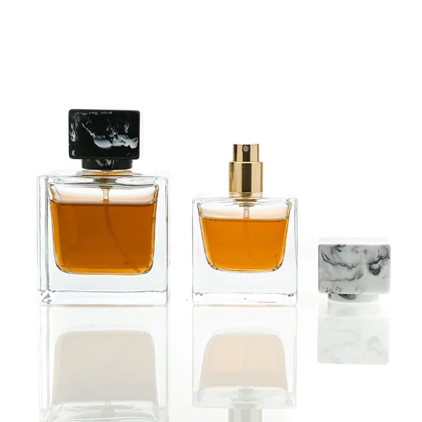 HUA0030 perfume bottle, heavy-base rectangular cuboid glass bottle with clear finish, featuring a matching neck, and a low-profile cylindrical resin cap with a colorful marbled finish, elegant modern fragrance packaging design available in 30ml, 50ml, and 100ml