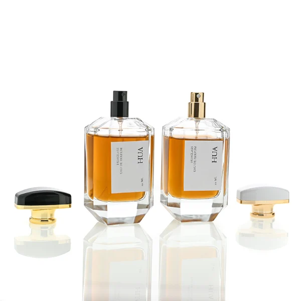 HUA0013 perfume bottle, heavy-base octagonal faceted glass bottle with clear finish, featuring a square paper label, a matching neck, and an arched rectangular plastic cap with a smooth high-gloss shiny finish, elegant modern fragrance packaging design available in 30ml, 50ml, and 100ml