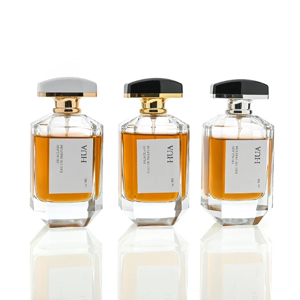 HUA0013 perfume bottle, heavy-base octagonal faceted glass bottle with clear finish, featuring a square paper label, a matching neck, and an arched rectangular plastic cap with a smooth high-gloss shiny finish, elegant modern fragrance packaging design available in 30ml, 50ml, and 100ml
