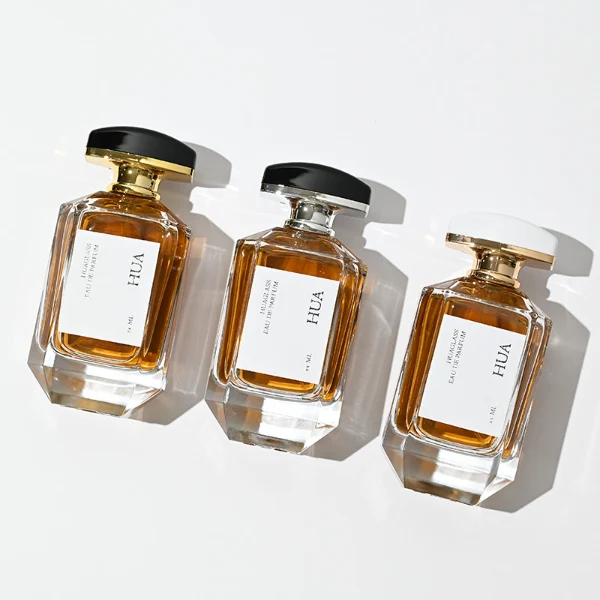 HUA0013 perfume bottle, heavy-base octagonal faceted glass bottle with clear finish, featuring a square paper label, a matching neck, and an arched rectangular plastic cap with a smooth high-gloss shiny finish, elegant modern fragrance packaging design available in 30ml, 50ml, and 100ml