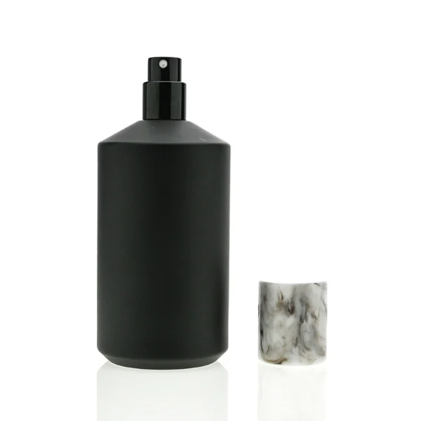 HUA0038 perfume bottle, heavy-base cylindrical round glass bottle with clear or solid high-gloss opaque black finish and unique chamfered sloping shoulders, featuring a tall cylindrical resin cap with an eye-catching marbled texture, elegant modern fragrance packaging design available in 30ml, 50ml, and 100ml