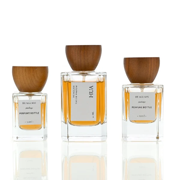 HUA0002 perfume bottle, heavy-base rectangular cuboid glass bottle with clear finish, featuring a square paper label, a matching neck, and an inverted conical timber cap with a natural grain finish, elegant modern fragrance packaging design available in 30ml, 50ml, and 100ml