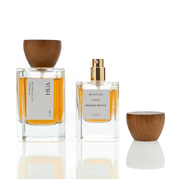 HUA0002 perfume bottle, heavy-base rectangular cuboid glass bottle with clear finish, featuring a square paper label, a matching neck, and an inverted conical timber cap with a natural grain finish, elegant modern fragrance packaging design available in 30ml, 50ml, and 100ml