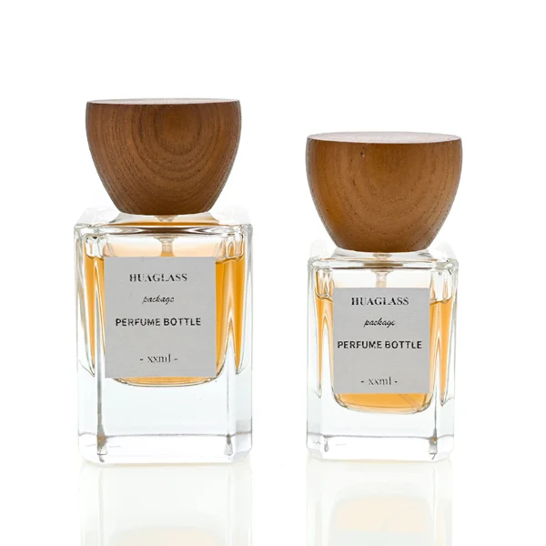HUA0002 perfume bottle, heavy-base rectangular cuboid glass bottle with clear finish, featuring a square paper label, a matching neck, and an inverted conical timber cap with a natural grain finish, elegant modern fragrance packaging design available in 30ml, 50ml, and 100ml