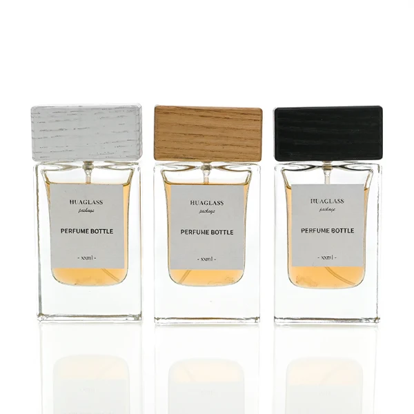 HUA0020 perfume bottle, heavy-base rectangular cuboid glass bottle with clear finish, featuring a square paper label, a matching neck, and a block-shaped rectangular timber cap with a natural smooth grain finish, elegant modern fragrance packaging design available in 30ml, 50ml, and 100ml