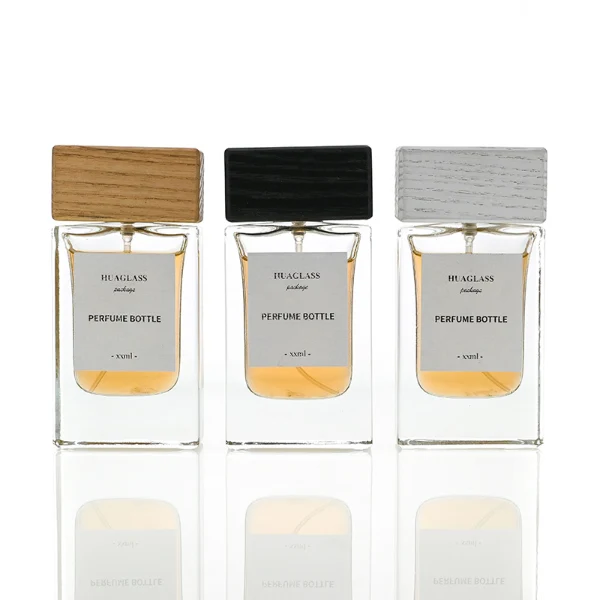 HUA0020 perfume bottle, heavy-base rectangular cuboid glass bottle with clear finish, featuring a square paper label, a matching neck, and a block-shaped rectangular timber cap with a natural smooth grain finish, elegant modern fragrance packaging design available in 30ml, 50ml, and 100ml