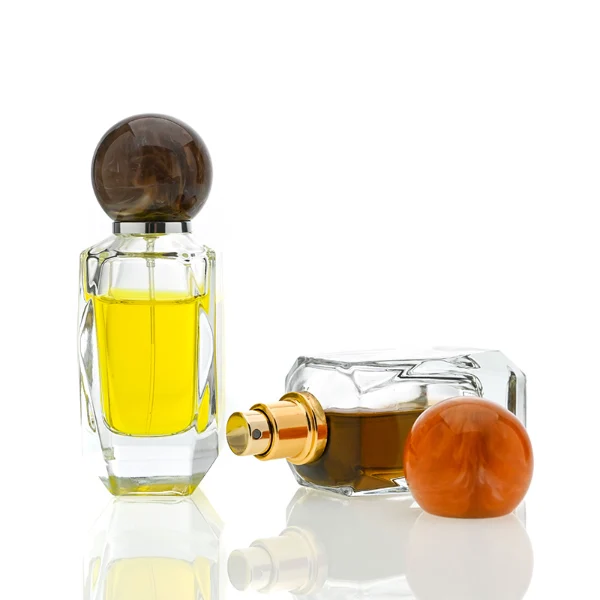 HUA0034 perfume bottle, heavy-base cylindrical glass bottle with a faceted shoulder and clear finish, featuring a square paper label, a polished gold or silver neck, and a tall cylindrical resin cap with a colorful marbled finish, elegant modern fragrance packaging design available in 50ml