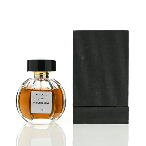 HUA0012 perfume bottle, heavy-base ribbed spherical round glass bottle with clear finish, featuring a square paper label, a matching neck, and a wide cylindrical plastic cap with a smooth high-gloss shiny black finish, elegant modern fragrance packaging design available in 100ml