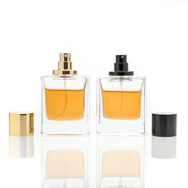 HUA0065 perfume bottles, rectangular clear glass with gold and black metallic caps, amber liquid, modern elegant design, 35ml 50ml 100ml.