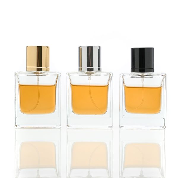 HUA0065 perfume bottles, rectangular clear glass with gold and black metallic caps, amber liquid, modern elegant design, 35ml 50ml 100ml.