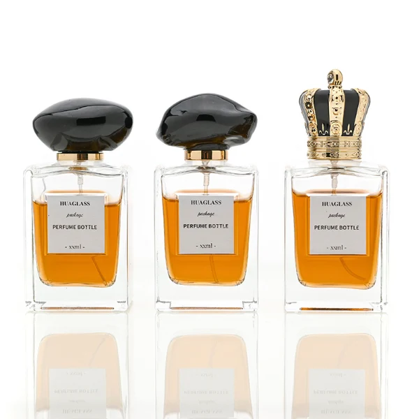 HUA0066 perfume bottles, rectangular clear glass with irregular black plastic caps, amber liquid, modern elegant design, 50ml 100ml.