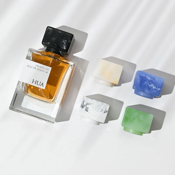 HUA0067 50ml perfume bottle, rectangular clear glass with rectangular colorful plastic cap, amber liquid, modern artistic design.