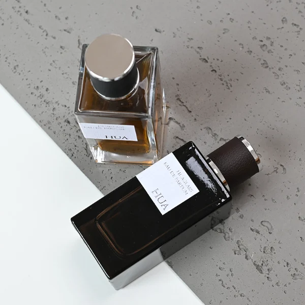 HUA0075 perfume bottle, rectangular clear glass, plastic cap with leather overlay, modern luxurious design, available in 30 ml, 50 ml, and 100 ml