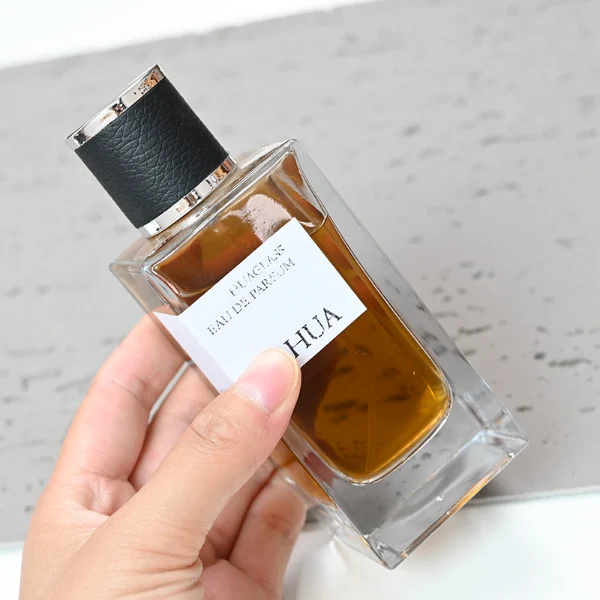 HUA0075 perfume bottle, rectangular clear glass, plastic cap with leather overlay, modern luxurious design, available in 30 ml, 50 ml, and 100 ml