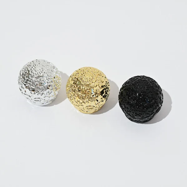 HUA0076 perfume bottle, cylindrical clear glass with liquid, ornate textured spherical cap in silver gold or black finish, modern elegant design, available in 35 ml, 50 ml, and 100 ml