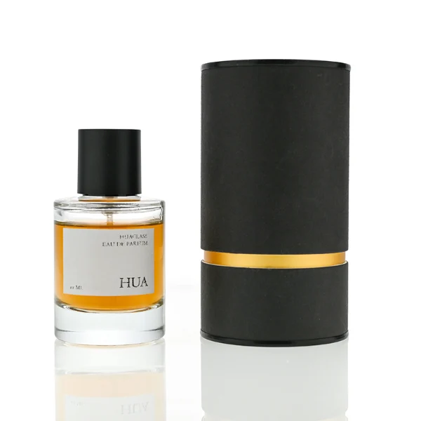 HUA0079 perfume bottle, cylindrical clear glass with liquid, glossy black aluminum magnetic cap, modern minimalist design, available in 30 ml, 50 ml, and 100 ml