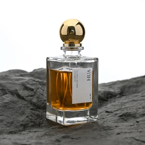 HUA0084 perfume bottle, rectangular glass with liquid, glossy plastic spherical cap, modern elegant design, available in 30 ml, 50 ml, and 100 ml