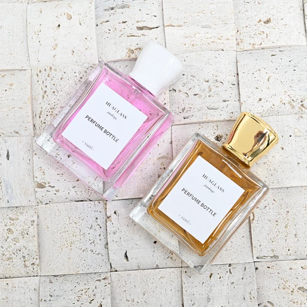 HUA0086 perfume bottle, square glass with liquid, glossy tapered plastic cap, modern elegant design, available in 30 ml, 50 ml, and 100 ml