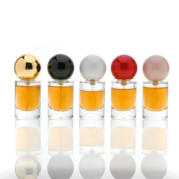HUA0088 perfume bottle, cylindrical internally sprayed glass with liquid, glossy spherical plastic cap in various colors, modern elegant design, available in 15 ml, 20 ml, and 30 ml