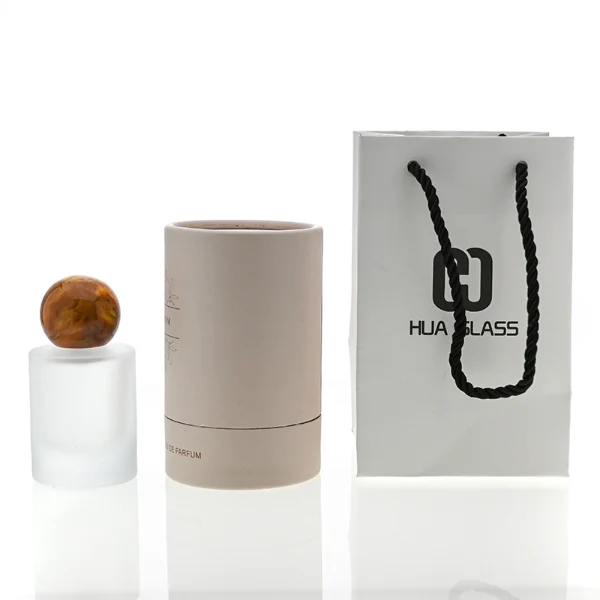 HUA0091 perfume bottle, cylindrical frosted white glass with liquid, colorful synthetic resin spherical cap, modern elegant design, available in 30 ml, 50 ml, and 100 ml