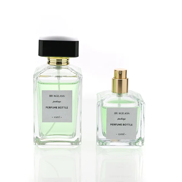 HUA0092 perfume bottle, rectangular column clear glass body with green-tinted liquid, black flat rectangular plastic cap, modern minimalist design, available in 30 ml, 50 ml, and 100 ml.