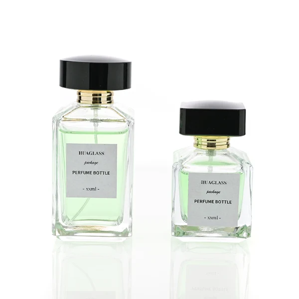 HUA0092 perfume bottle, rectangular column clear glass body with green-tinted liquid, black flat rectangular plastic cap, modern minimalist design, available in 30 ml, 50 ml, and 100 ml.