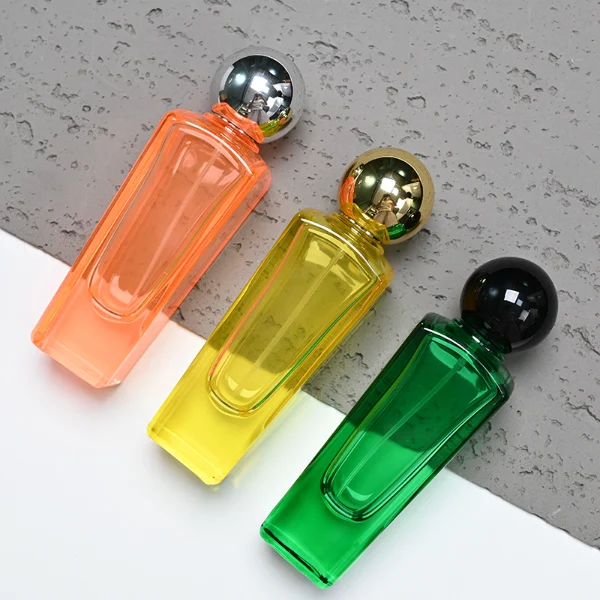 HUA0095 perfume bottle, tall rectangular colored glass body with embossed side details, glossy spherical plastic cap, modern artistic design, available in 50 ml.