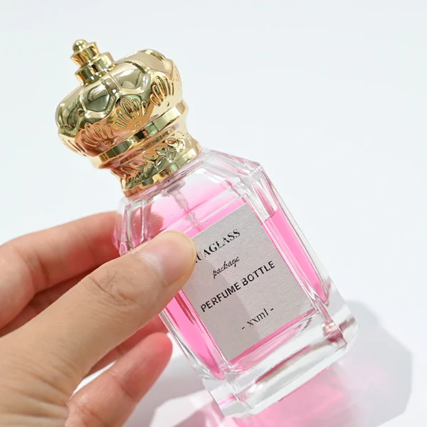 HUA0099 perfume bottle, faceted clear glass with liquid, glossy crown-shaped plastic cap, modern elegant design, available in 50 ml and 75 ml