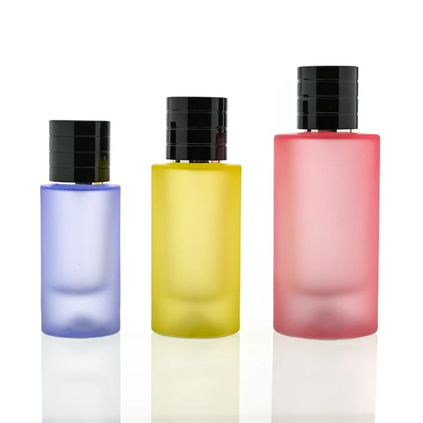 HUA0105 perfume bottle, cylindrical colored frosted glass body with aluminum cap featuring layered ring texture and glossy finish, modern minimalist design, available in 30 ml, 50 ml, and 100 ml.