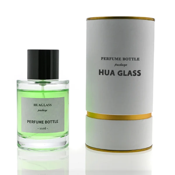 HUA0108 perfume bottle, cylindrical glass body with liquid and outer label, glossy black plastic cylindrical cap with silver metallic neck, modern elegant design, available in 30 ml, 50 ml, and 100 ml.