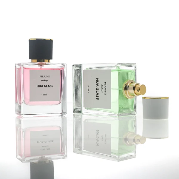 HUA0111 perfume bottle, square glass body with liquid and outer label, cylindrical plastic cap with gold metallic neck, modern minimalist design, available in 30 ml, 50 ml, and 100 ml.