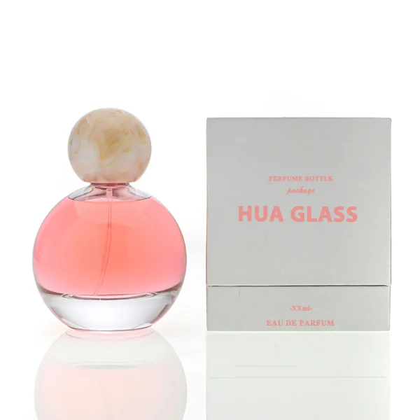 HUA0114 perfume bottle, transparent spherical glass with colorless liquid, resin marble-texture and black ball-shaped caps, label-free modern minimalist design, available in 30 ml, 50 ml, and 100 ml
