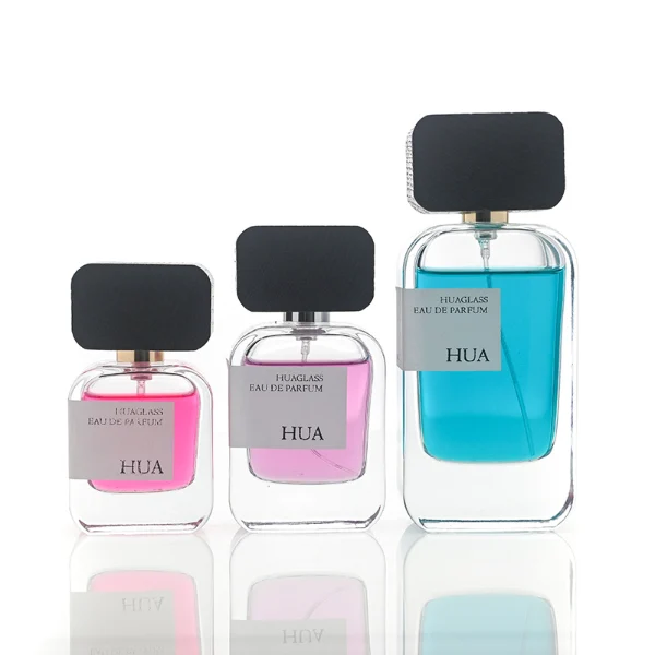 HUA0116 perfume bottle, rounded rectangular glass body with outer label, black rectangular plastic cap with yellow or silver neck accents, modern elegant design, available in 30 ml, 50 ml, and 100 m