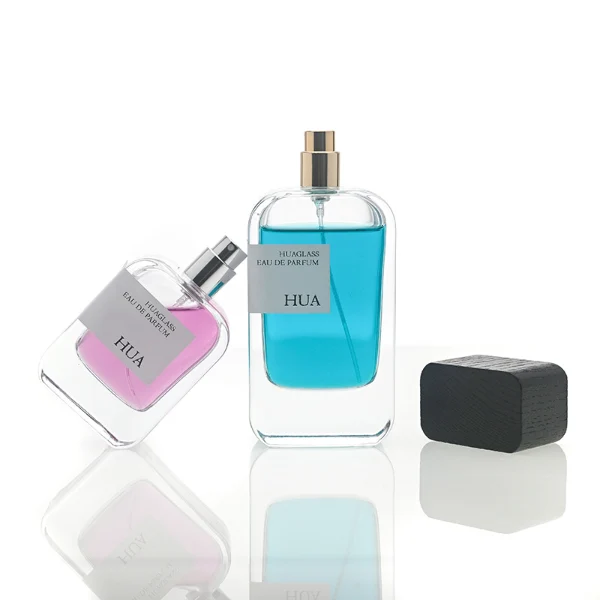 HUA0116 perfume bottle, rounded rectangular glass body with outer label, black rectangular plastic cap with yellow or silver neck accents, modern elegant design, available in 30 ml, 50 ml, and 100 m