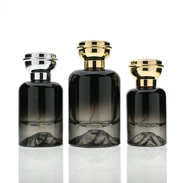 HUA0119 perfume bottle, gradient cylindrical glass with mountain-pattern base, glossy colored plastic cap in gold and silver tones, modern premium design, available in 30 ml, 50 ml, and 100 ml