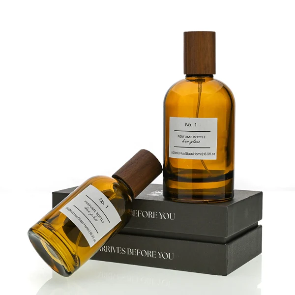 HUA0120 perfume bottle, amber cylindrical glass with outer label, tall wooden cylindrical cap, minimalist contemporary design, available in 30 ml, 50 ml, and 100 ml