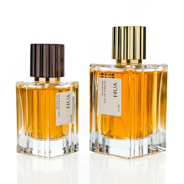 HUA122 perfume bottle, vertically faceted rectangular clear glass body with outer label, striped cylindrical plastic cap in black or gold, modern elegant design, available in 50 ml and 100 ml.