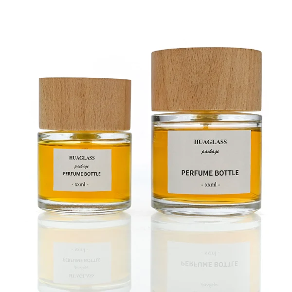 HUA0123 perfume bottle, rounded cylindrical clear glass with outer label, wide wooden cylindrical cap, minimalist modern design, available in 30 ml, 50 ml, and 100 ml